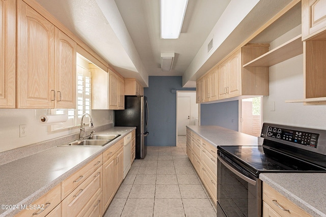 kitchen featuring appliances with stainless steel finishes, plenty of natural light, light brown cabinetry, and sink