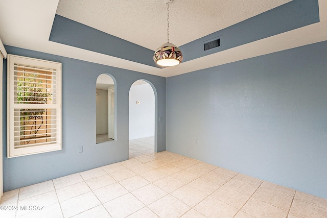 empty room featuring a textured ceiling