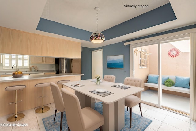 tiled dining room featuring sink