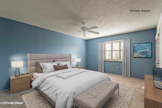 bedroom featuring light tile patterned floors, a textured ceiling, and ceiling fan