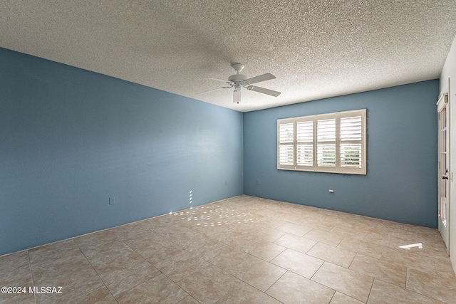 spare room with a textured ceiling and ceiling fan