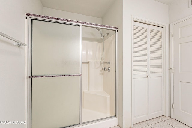 bathroom featuring tile patterned flooring and an enclosed shower