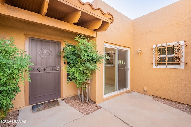 entrance to property featuring a patio area