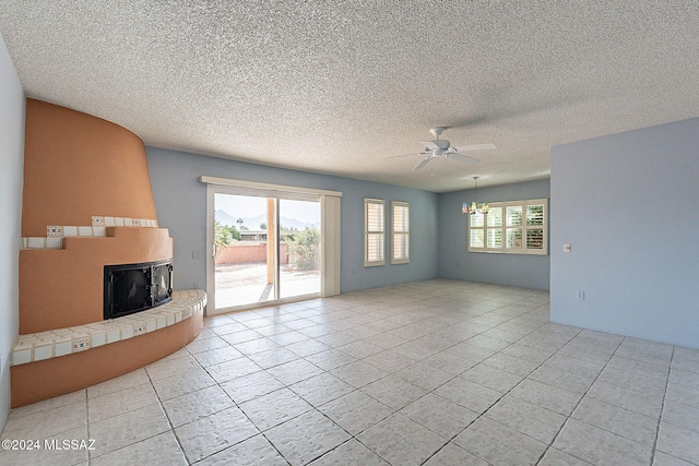 unfurnished living room with light tile patterned floors, a textured ceiling, and ceiling fan