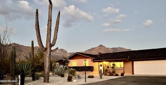 ranch-style house with a mountain view and a garage