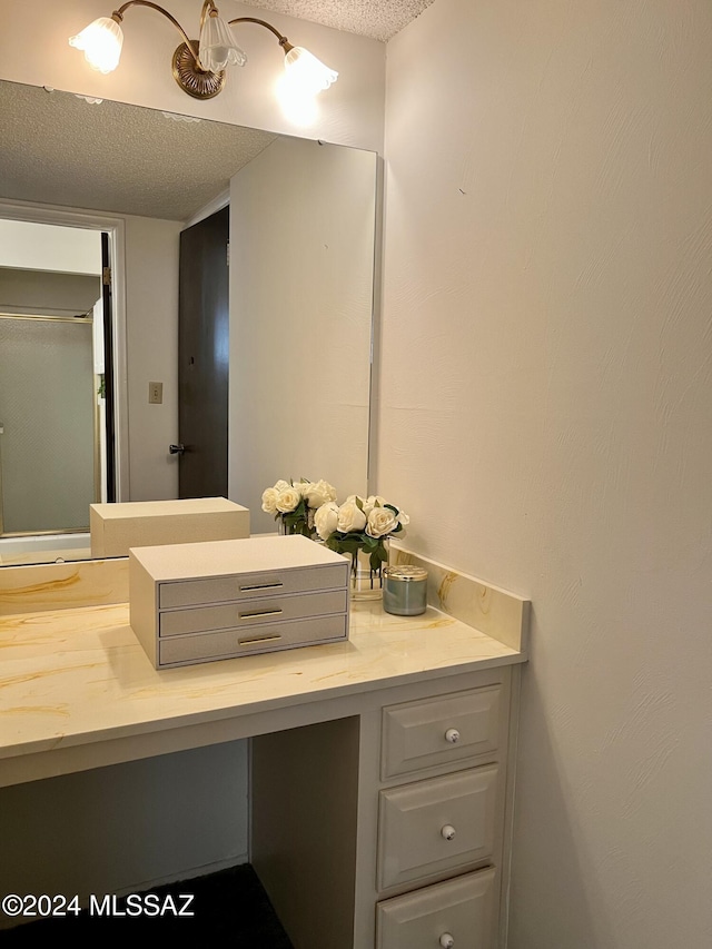 bathroom with vanity and a textured ceiling