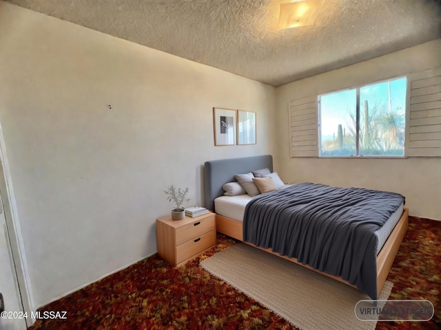 carpeted bedroom with a textured ceiling