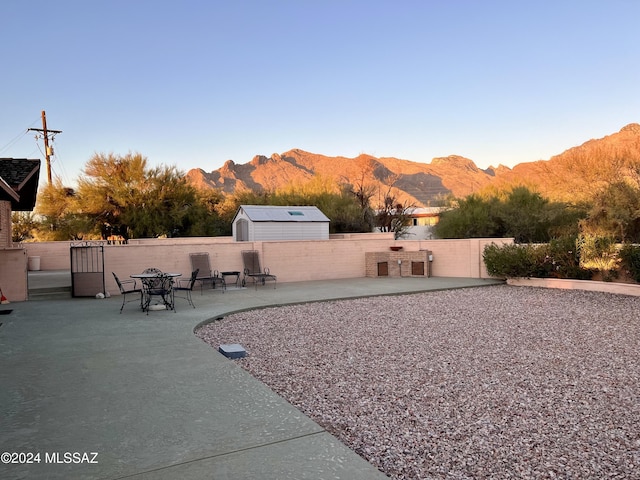 view of yard with a mountain view and a patio area