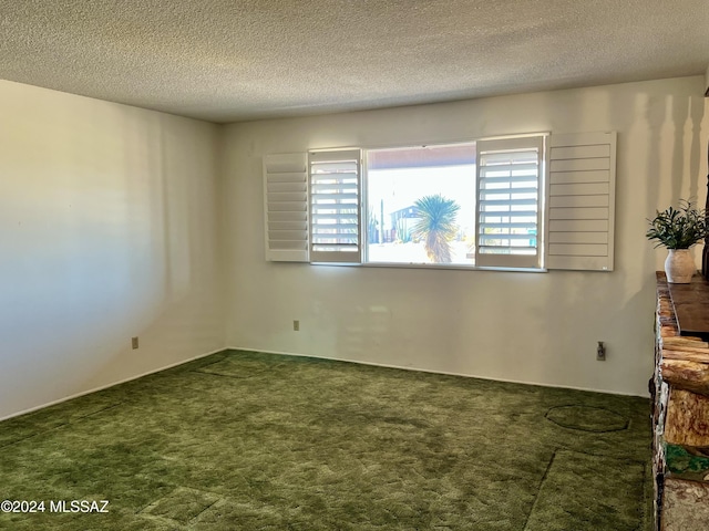 spare room with carpet flooring and a textured ceiling