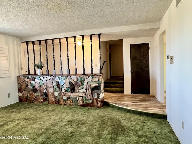 interior space featuring carpet floors and a textured ceiling