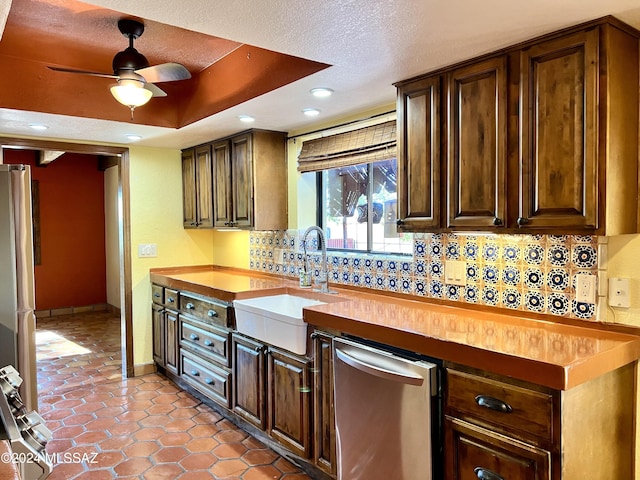 kitchen with backsplash, butcher block counters, and sink