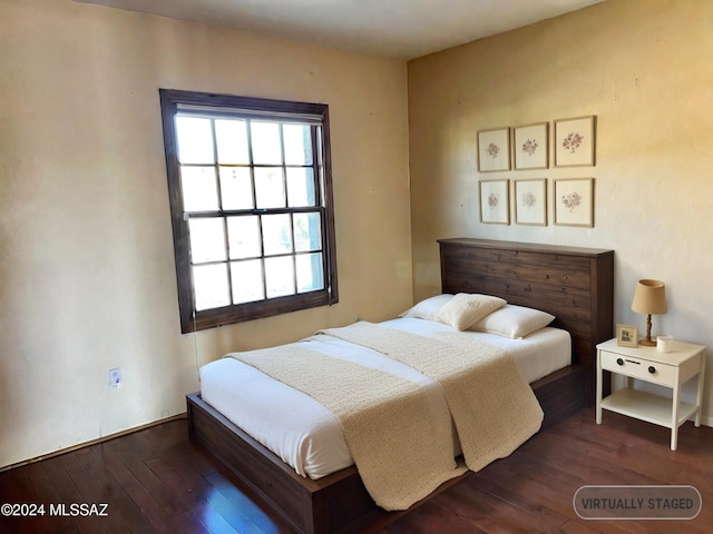 bedroom with dark hardwood / wood-style floors