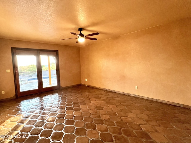 unfurnished room featuring french doors, a textured ceiling, and ceiling fan