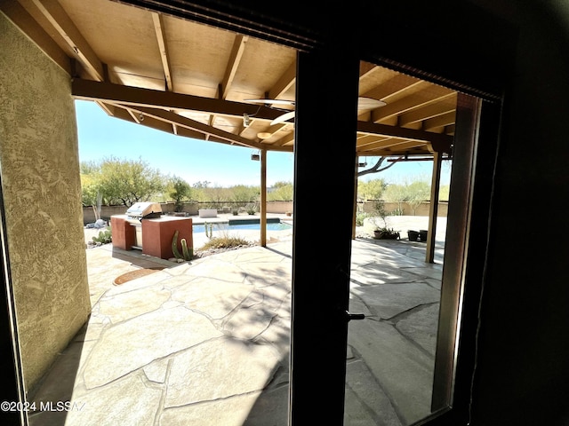 view of patio / terrace with area for grilling and a fenced in pool