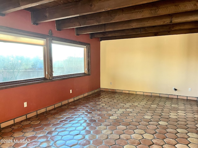 spare room with beam ceiling