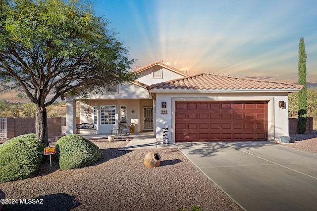 mediterranean / spanish home featuring a garage