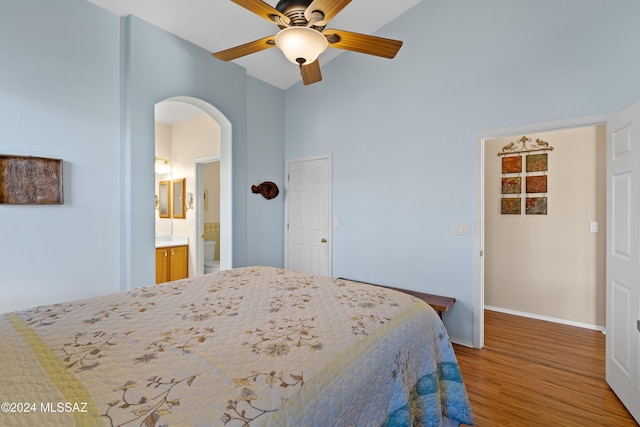 bedroom with connected bathroom, ceiling fan, and hardwood / wood-style floors