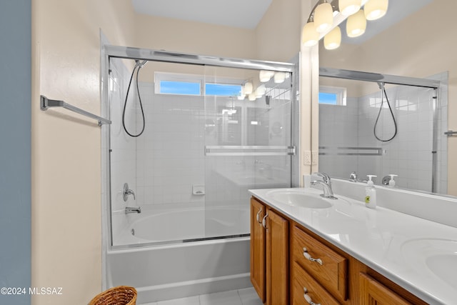 bathroom featuring tile patterned floors, vanity, and enclosed tub / shower combo