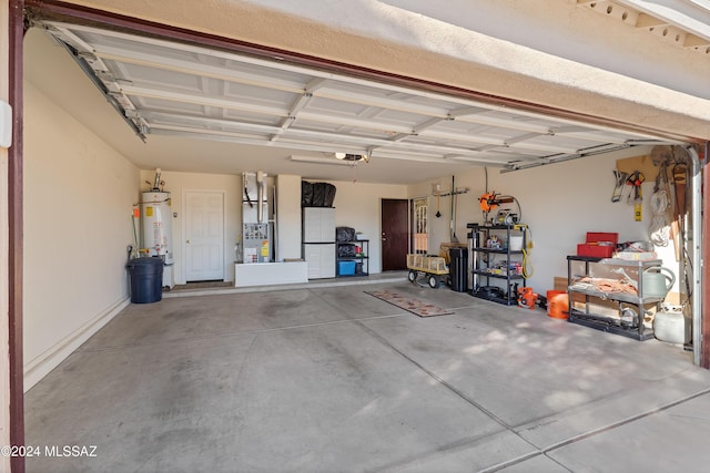 garage with water heater, a garage door opener, and white refrigerator