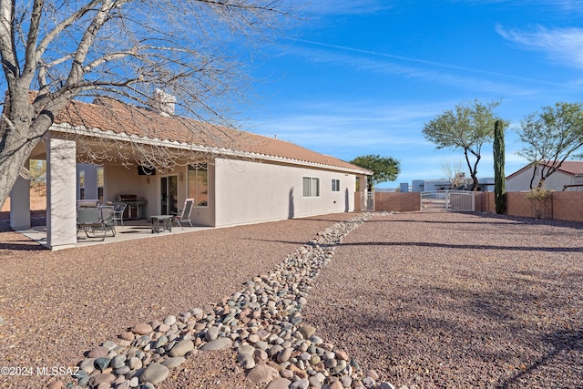 back of house with a patio area