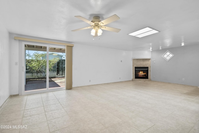 unfurnished living room featuring ceiling fan and a premium fireplace