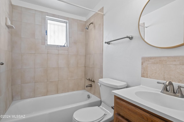 full bathroom featuring vanity, toilet, and tiled shower / bath