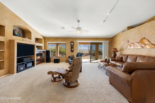 carpeted living room with lofted ceiling, ceiling fan, and rail lighting