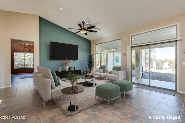 living room featuring ceiling fan and lofted ceiling