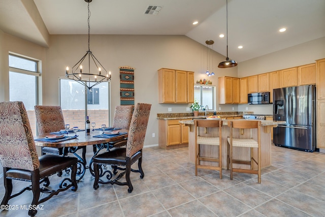 kitchen featuring an inviting chandelier, light stone countertops, light brown cabinetry, decorative light fixtures, and stainless steel fridge with ice dispenser