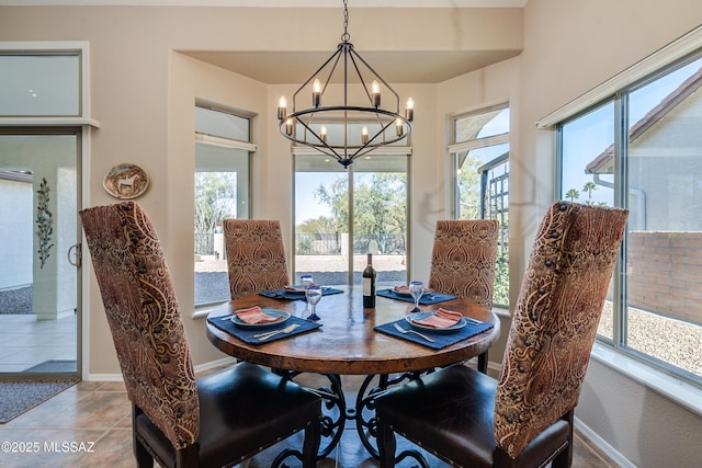 dining area with tile patterned flooring and an inviting chandelier