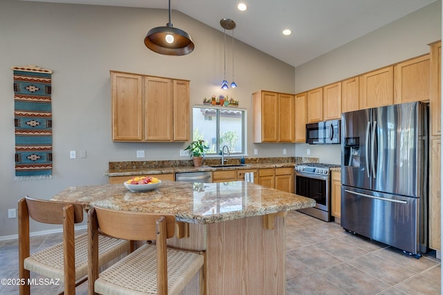 kitchen featuring hanging light fixtures, sink, light stone countertops, light brown cabinetry, and appliances with stainless steel finishes