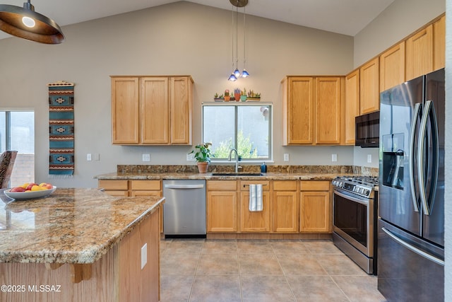 kitchen featuring high vaulted ceiling, hanging light fixtures, sink, appliances with stainless steel finishes, and light stone counters