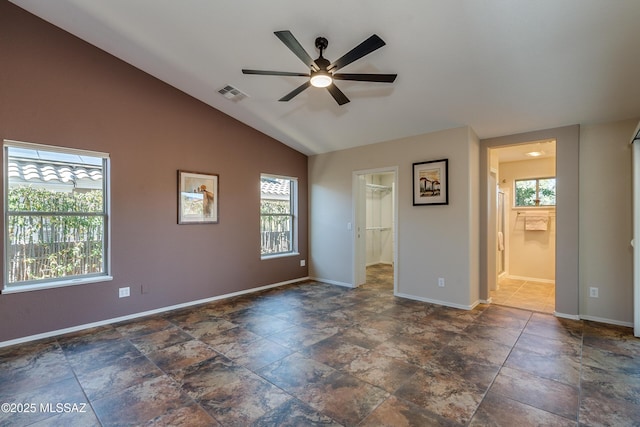 spare room with ceiling fan and vaulted ceiling