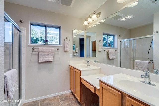 bathroom with tile patterned flooring, vanity, and a shower with shower door