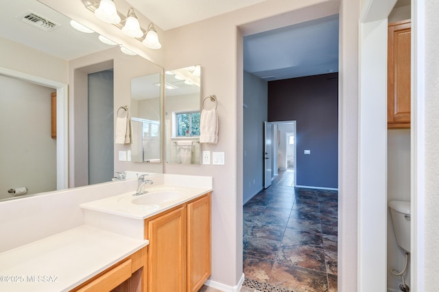 bathroom with vanity and toilet