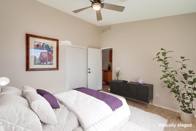 bedroom with tile patterned flooring and ceiling fan