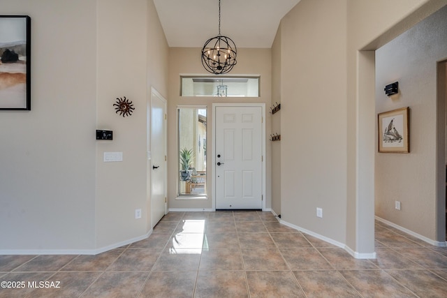 entryway with a high ceiling and a notable chandelier