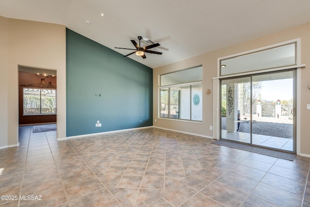 spare room with ceiling fan, lofted ceiling, and light tile patterned floors