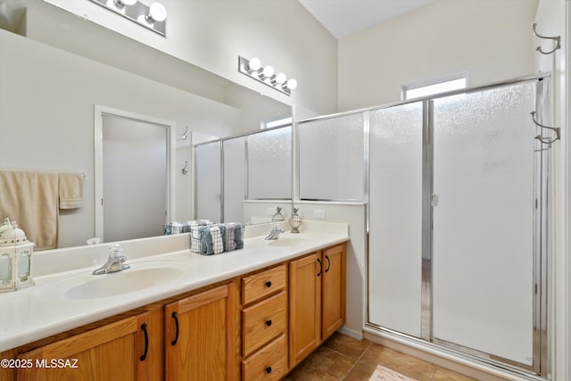 bathroom featuring a shower with door, tile patterned floors, and vanity