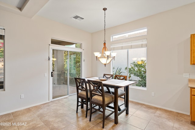 tiled dining space featuring a notable chandelier