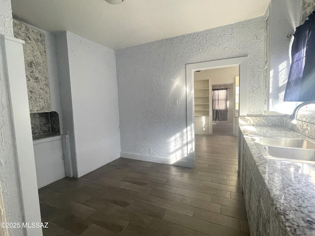 hall with dark hardwood / wood-style flooring and sink