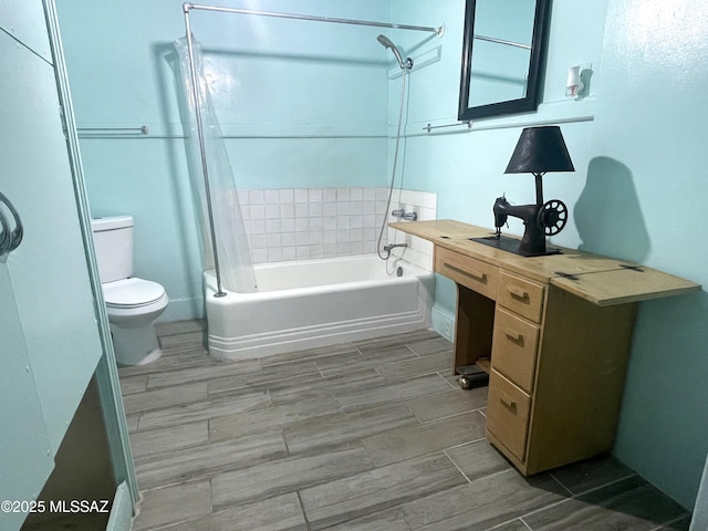 bathroom featuring shower / tub combo and toilet