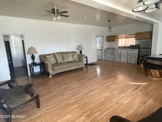 living room with ceiling fan and light wood-type flooring