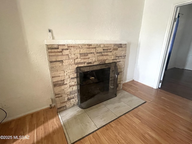 interior details with wood-type flooring and a fireplace