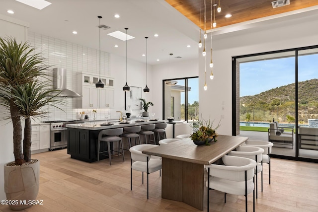 dining area with a mountain view and light hardwood / wood-style flooring