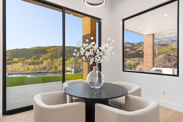 dining area featuring a mountain view and light hardwood / wood-style floors