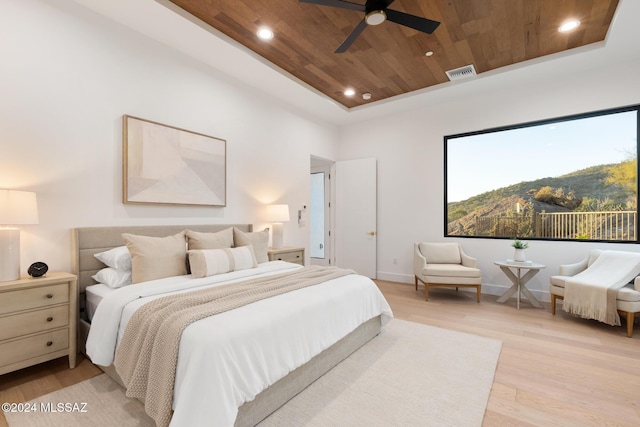 bedroom featuring ceiling fan, a mountain view, wood ceiling, and light hardwood / wood-style floors