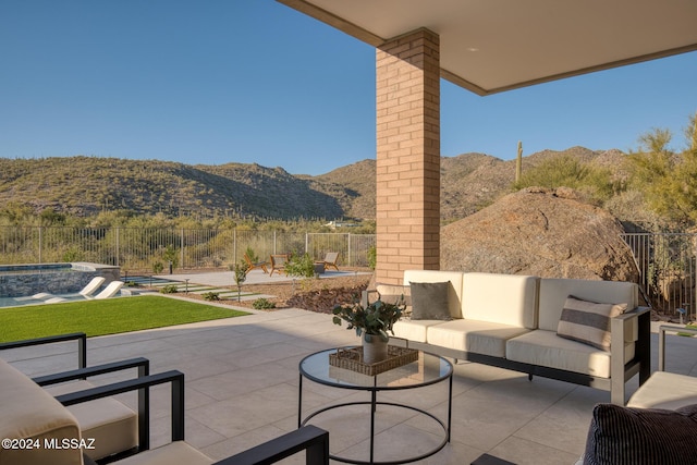 view of patio / terrace featuring a mountain view, a pool with hot tub, and an outdoor hangout area