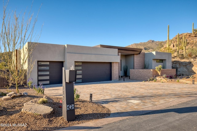 view of front of home featuring a mountain view and a garage
