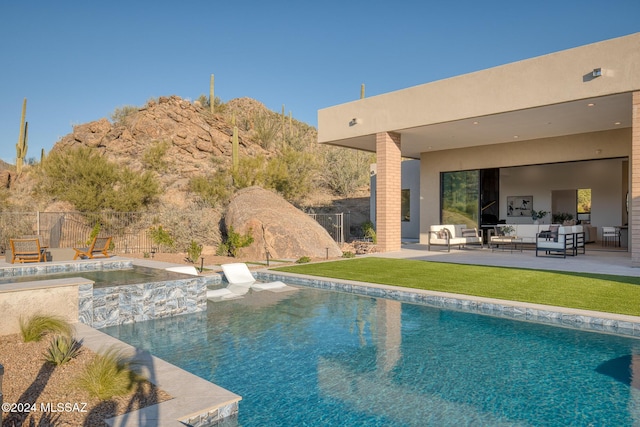 view of swimming pool featuring an outdoor living space and a patio